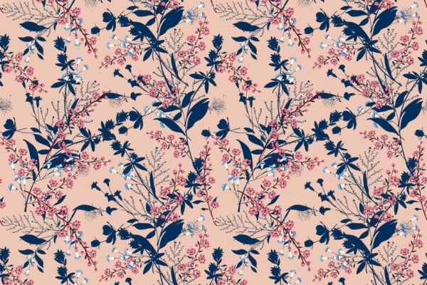 A seamless wallpaper pattern showcasing dark blue botanical silhouettes of assorted leaves and flowers, embellished with delicate pink and light blue floral accents. All elements rest against a soft peach background, creating a harmonious serenade of nature’s elegance.