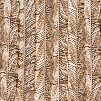Close-up of an intricate woven pattern crafted from natural plant fibers, featuring a textured surface with interlaced strands in shades of brown and beige. The rustic, traditional design mirrors the craftsmanship seen at The Boma. Highlighted elements: natural plant fibers, textured surface, interlaced strands, shades of brown and beige.