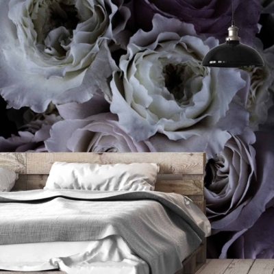Large floral mural featuring white and purple roses. It adds a touch of romance to the room with its elegant and vibrant design. The wallpaper enhances the modern, rustic aesthetic by incorporating natural elements and sophisticated colors, creating a serene backdrop for the bedroom's décor.