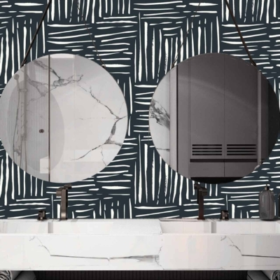 A modern bathroom features wallpaper with a black and white abstract pattern.
