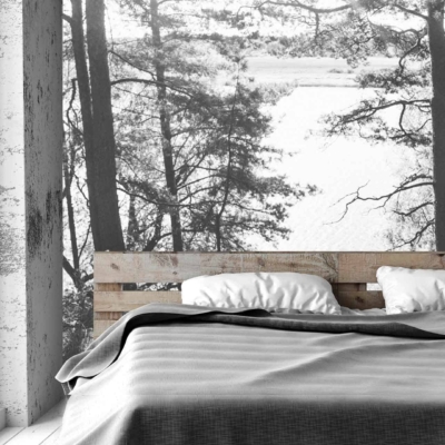 The wallpaper in the bedroom features a black-and-white mural of a forest and lake. Intricate trees, serene water, and natural elements dominate the scene, providing an elegant yet tranquil backdrop.