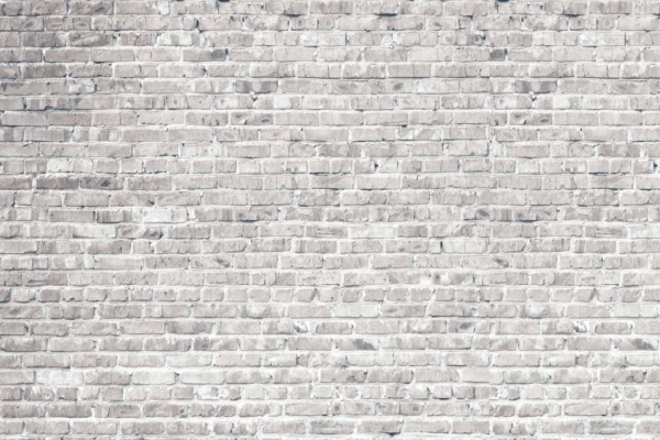 White-washed brick wall wallpaper with a slightly weathered texture. Bricks laid in a horizontal pattern with varying shades of white and gray. Aged, rustic appearance; urban charm.