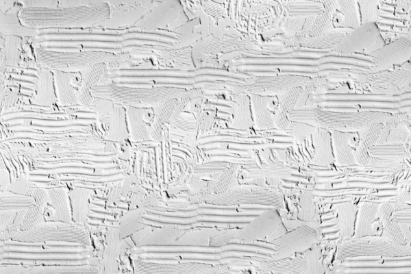 Close-up of textured white wallpaper with wayward, intricate patterns from sweeping and overlapping strokes. The surface is rough, featuring a blend of smooth and ridged areas, likely formed with a trowel on plaster or stucco. The color palette is predominantly off-white with subtle variations adding depth and dimension to the wallpaper design.