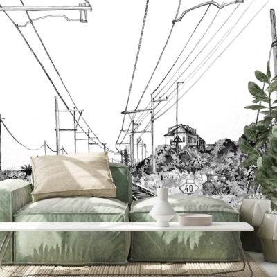 A black-and-white mural depicting power lines, road signs, and a rail crossing in Kalk Bay.