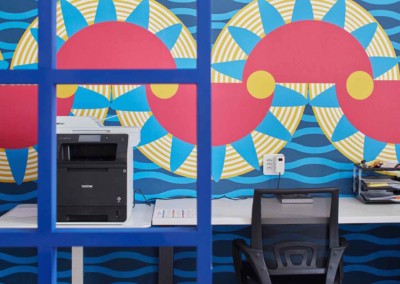 Bold, colorful wall mural. Features red, yellow, and blue geometric patterns.