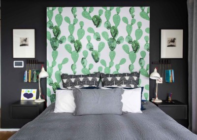 Colorful cactus-patterned wallpaper featuring vibrant shades of green, pink, yellow, and blue elements.