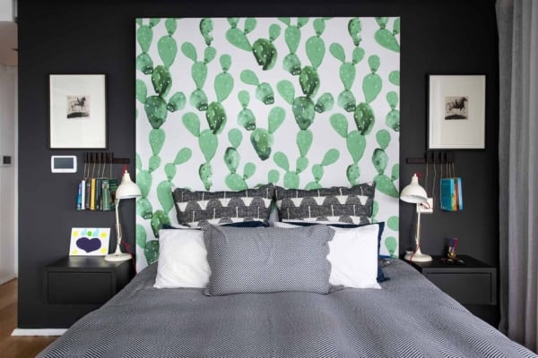 Colorful cactus-patterned wallpaper featuring vibrant shades of green, pink, yellow, and blue elements.