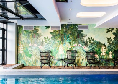 Lush green foliage, pink flowers, intricate leaves, vibrant colors, botanical theme, jungle-inspired pattern.