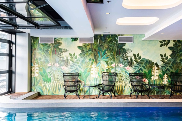 Lush green foliage, pink flowers, intricate leaves, vibrant colors, botanical theme, jungle-inspired pattern.