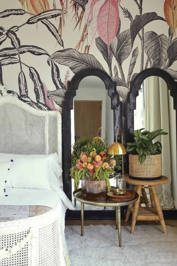 Nature-themed mural featuring large leaves and flowers. Key elements: green foliage, varied shades of green, vibrant petals in hues of pink, yellow, and orange, naturalistic details with a botanical focus.