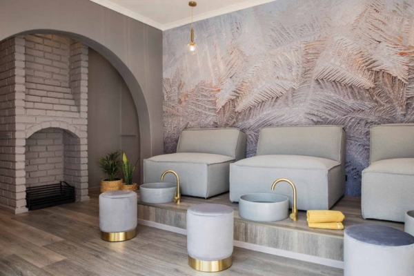 The wallpaper features a fern pattern with various shades of green, ranging from deep forest to light moss. The background is a soft off-white, enhancing the natural and calming aesthetic.