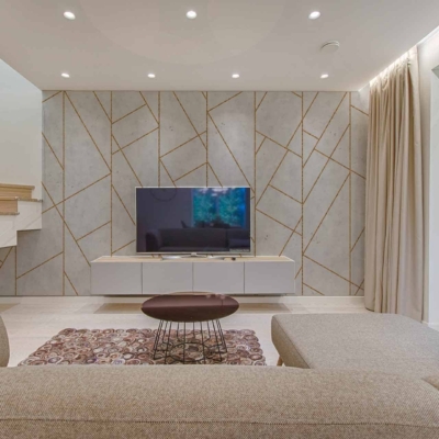 The wallpaper features geometric patterns, with elements in shades of taupe, ivory, and subtle gold accents.