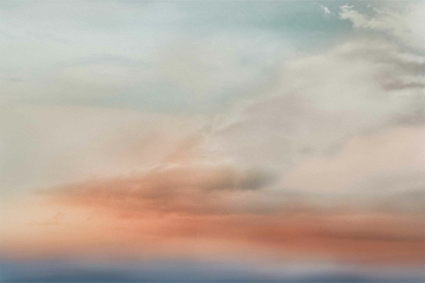 Pastel-toned sky wallpaper features serene gradients of blue, pink, and soft orange. Delicate, wispy clouds enhance the tranquil sunrise or sunset atmosphere. Dreamy and soothing patterns evoke a calm ambiance perfect for peaceful settings.