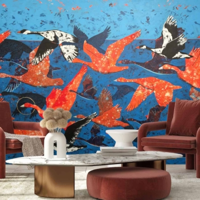 A vibrant mural of red, orange, and black birds flying against a bright blue background.