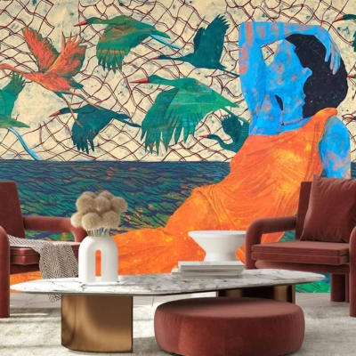 The wallpaper features a blue-skinned person in an orange dress, surrounded by netting and green birds. The backdrop includes modern elements like two red armchairs, a white and gold pedestal coffee table, and a decorative vase with pampas grass. Key colors are blue, orange, green, red, white, gold.