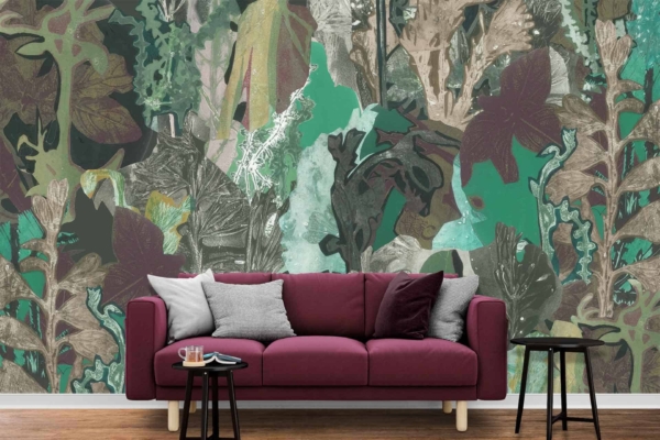The wall mural behind the sofa features an abstract, leafy pattern with shades of green, brown, and teal—perfect for fans of natural living.