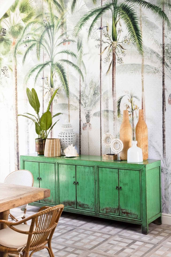 Wallpaper featuring a vivid tropical palm tree mural with lush green fronds and rich brown trunks, set against a backdrop of deep blue sky with hints of turquoise.