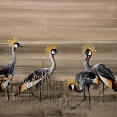 A wallpaper features six crowned cranes with golden crests, set in a grassy landscape. The backdrop consists of muted earth tones adding depth and texture. Elements: graceful birds, gold accents on heads, grassy scenery, earthy shades.