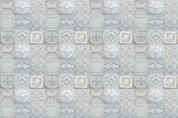 Victorian-style wallpaper with square tiles, intricate designs including floral motifs and geometric shapes, soft muted color palette of light gray and off-white. Elegant and ornate.