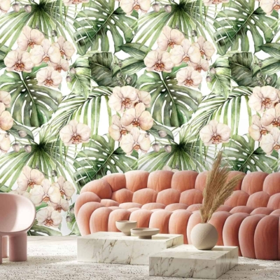 The wallpaper is adorned with a vibrant mix of floral and tropical leaf patterns. Colors include lush greens, soft pinks, bold fuchsias, and hints of creamy whites. Large palm leaves interweave with exotic flowers like hibiscus and orchids, creating an energetic yet harmonious blend of natural elements.
