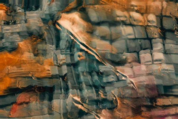 Abstract wallpaper features a distorted, fluid-like pattern with various shades of orange, blue, and green. Colors blend and swirl like Japanese Fishes. Textured effect resembles waves or currents overlaid on a checkered background. Elements include abstract swirls, wave-like textures, and checkered overlay.