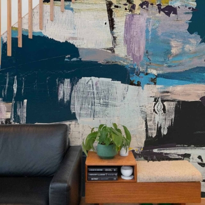 The wallpaper is a bold, abstract mural featuring deep blues, greens, and splashes of purple and white.