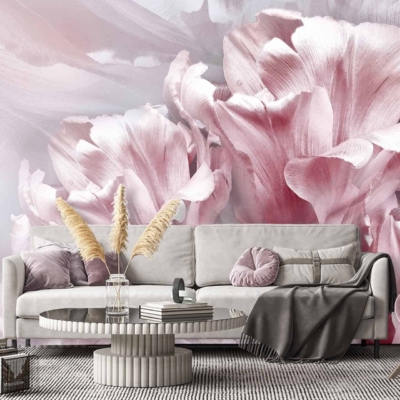 A modern living room features a large floral mural wallpaper dominated by soft pink and white tones. The design showcases intricate floral patterns, blending various shades of pink with delicate white accents. The flowers are detailed and create a serene and elegant atmosphere in the room. This stunning backdrop is the focal point, enhancing the overall aesthetic with its graceful blend of pastel hues. Perfect for searches related to