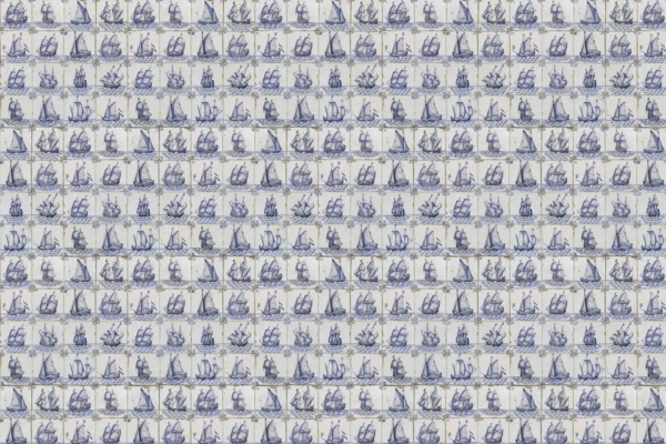 A wallpaper grid featuring small, intricate illustrations of various sailing ships in blue and white. Each vessel has detailed tall masts and sails, arranged in neat rows and columns. The light background incorporates an essence of African design elements. Key features: "sailing ships," "blue and white," "tall masts," "light background," "African essence.