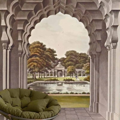 The wallpaper mural features an arched pathway leading to a serene garden. The pathway is flanked by lush greenery and vibrant flowers. In the distance, there's a classical pavilion and a tranquil fountain surrounded by trees. Elements include arches, pathways, fountains, gardens, trees, pavilions. Colors to note are green for foliage, various floral hues like pink and yellow, earthy tones for the pathway, blue for water in the fountain, and subtle pastels on the pavilion.
