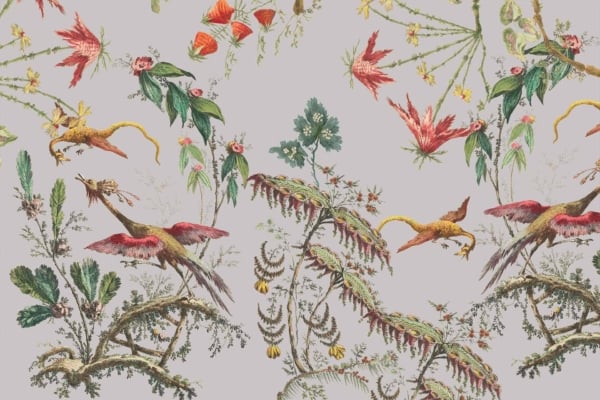 A detailed botanical illustration featuring vibrant flowers and green foliage intertwined with fantastical bird-like creatures with red wings and long yellow tails, set against a light grey background. Elements include intricate flowers, rich green leaves, fantasy birds with bright red wings, long yellow tails, and a soft grey backdrop.