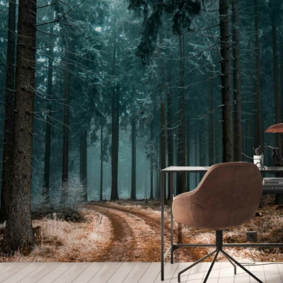 The wallpaper features an ethereal, misty forest path lined with tall trees and scattered leaves. The dominant colors are shades of green and brown from the foliage and tree trunks, with hints of soft gray mist adding a dreamy effect.