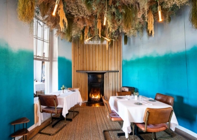 The wallpaper in the cozy dining room features a blue gradient design, transitioning from darker to lighter shades of blue.