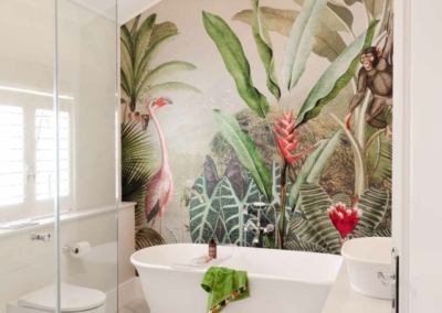 The wallpaper features vibrant tropical foliage with large green leaves, a pink flamingo, and a playful monkey.