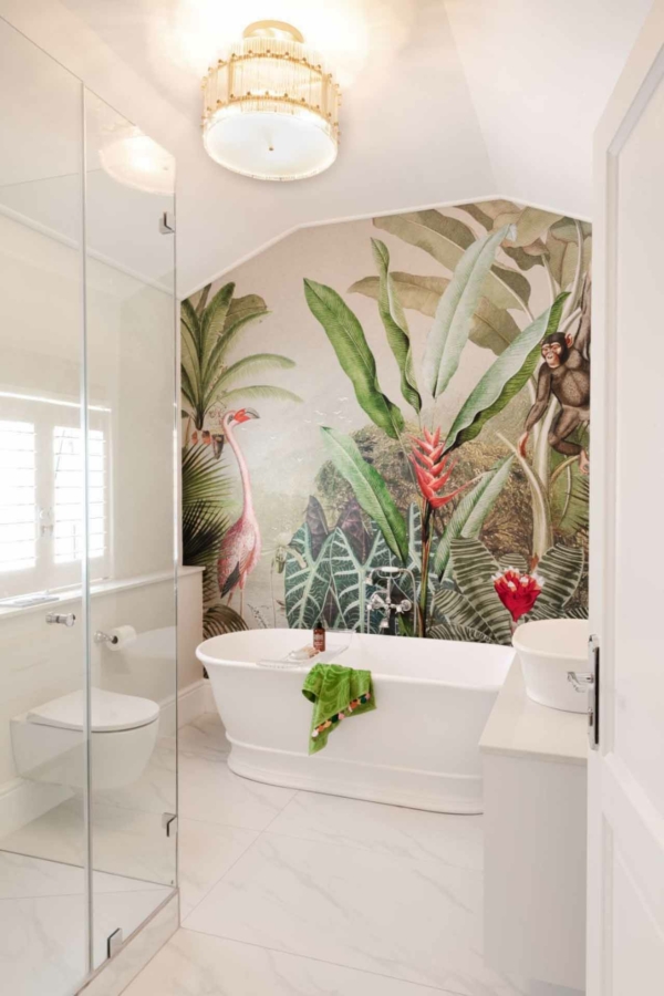 The wallpaper features vibrant tropical foliage with large green leaves, a pink flamingo, and a playful monkey.