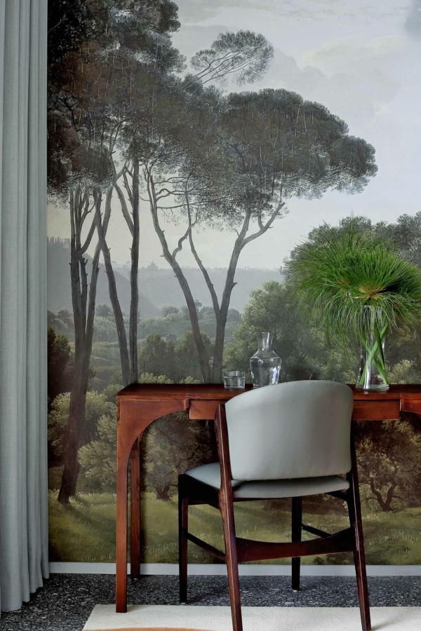 A mural featuring tall trees and lush greenery, showcasing vibrant greens, deep browns, and soft earth tones. The serene and nature-inspired design adds depth with its mix of light and dark foliage, creating a tranquil backdrop perfect for any space.