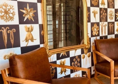 Checkered black and white wall, gold floral designs.