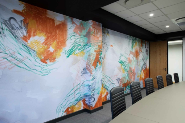 A vibrant, abstract mural with dynamic brush strokes in orange, green, and blue.