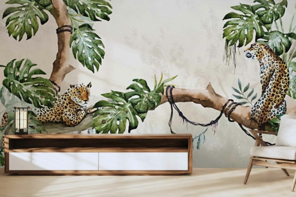 The wallpaper showcases two leopards lounging on tree branches with large green leaves. The background is light-colored, creating a serene, natural ambiance.