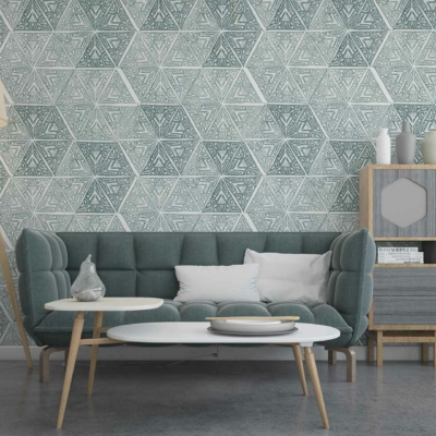 The wallpaper features a bold, geometric pattern with interlocking shapes. Dominant colors include shades of teal, mustard yellow, and white. Some areas have subtle silver accents that add a touch of metallic sheen. The geometric design creates a dynamic, contemporary feel perfect for modern living spaces.