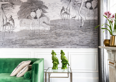A stylish living room features a large black-and-white mural of flamingos on the wall, creating a bold focal point with its intricate bird patterns and monochromatic color scheme.
