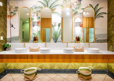 Wallpaper features: palm tree mural, lush green tones, tropical theme, leafy patterns.