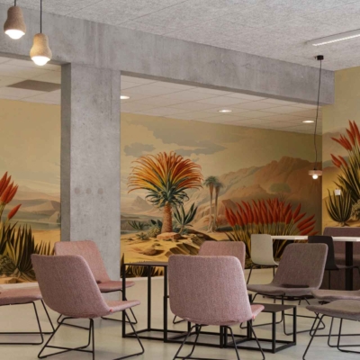 Desert-themed wallpaper featuring vibrant desert plants, cactus motifs, sandy dunes, succulent greenery and muted earth tones. Predominantly soft pinks, greens, beiges with touches of bright blooms stand out.