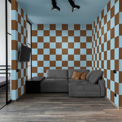 The room's wallpaper features a modern design with blue and brown checkered patterns. This striking combination of blue and brown adds a contemporary flair, forming both the walls and ceiling. The checkered pattern creates visual interest, complementing the overall modern aesthetic.