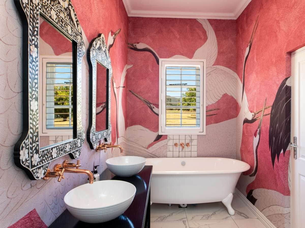 Bespoke pink wallpaper with a bird inspired design creating space in a small room
