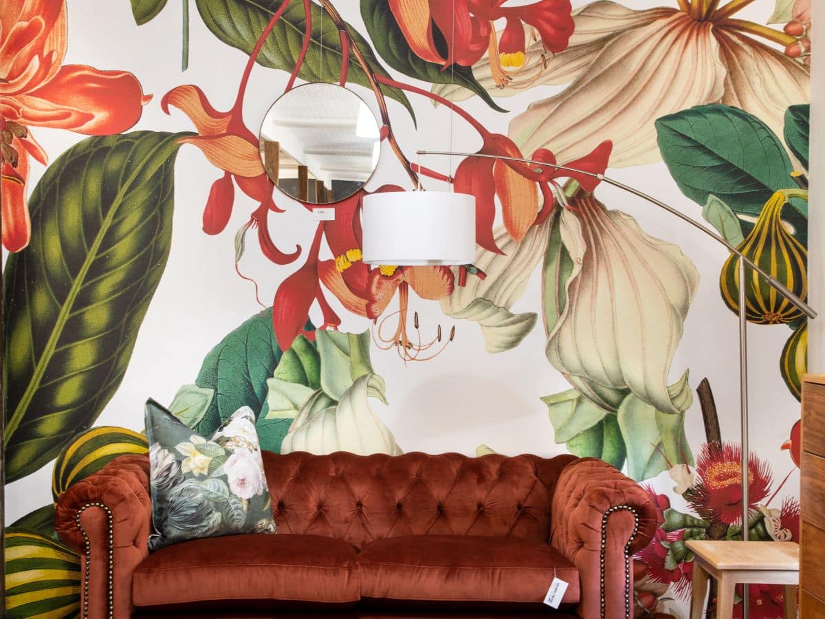 Floral wallpaper in the living room with a couch in the foreground