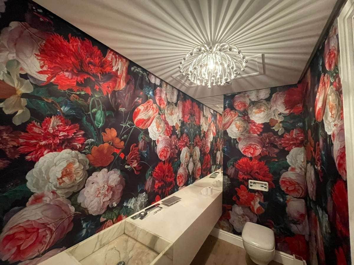 A rose wallpaper in a smaller space hotel bathroom