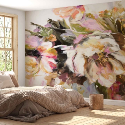 A large, vibrant floral mural covers one wall, featuring an array of blooming flowers in bold hues such as deep reds, vivid oranges, soft pinks, and lush greens. The intricate details showcase delicate petals and rich foliage with subtle brushstrokes adding depth. This eye-catching wallpaper infuses the bedroom with color and nature-inspired elegance.