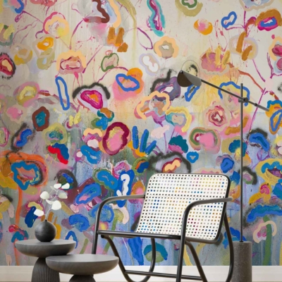 The wallpaper in this modern living space features a vibrant, abstract floral mural, displaying a dynamic array of colors such as bold reds, vivid blues, lively greens, and striking yellows. The design evokes the fluidity and grace of an elegant dance performance with its swirling patterns and intricate details.
