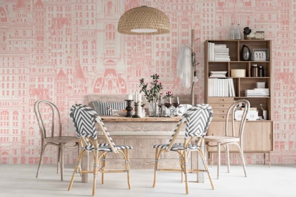 Patterned wallpaper with buildings in shades of pink and white, evoking cityscapes.