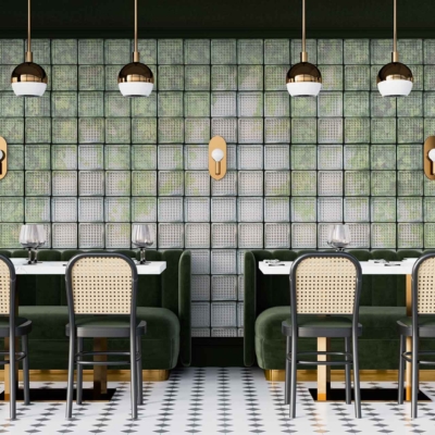 The wallpaper, reminiscent of elegant Glass Houses, features a lush botanical theme with an emerald green backdrop. It showcases intricate patterns of large, overlapping leaves in varying shades of green, accented with touches of white and gold to add depth and luxury. The design is meticulously detailed with hints of geometric lines interwoven between the foliage, creating a harmonious blend that complements the restaurant's art deco elements. Look for keywords: botanical theme, emerald green backdrop, intricate leaf patterns, shades of green, white accents, gold accents and geometric lines.